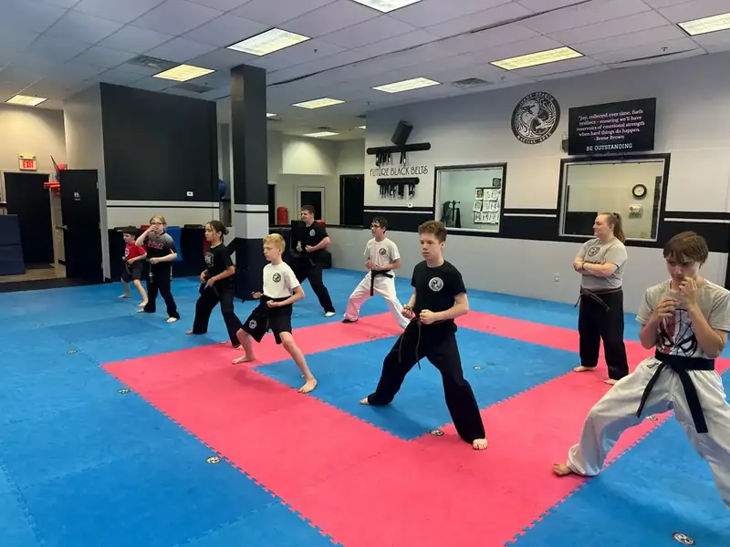 Inner Dragon students holding disciplined stances together during class in Hudson NH
